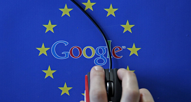 A woman hovers a mouse over the Google and European Union logos